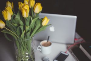 Laptop by vase of yellow tulips, Platinum Resumes, Kansas City, MO