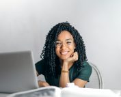 Woman smiling at laptop, Platinum Resumes, Kansas City, MO