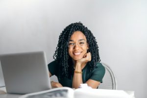 Woman smiling at laptop, Platinum Resumes, Kansas City, MO