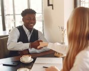 Man interviewing with woman, shaking hands, Platinum Resumes, Kansas City, MO
