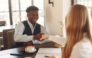 Man interviewing with woman, shaking hands, Platinum Resumes, Kansas City, MO