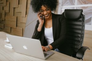 Woman laughing at her laptop, Platinum Resumes, Kansas City, MO