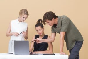 3 young people gathered around a laptop, Platinum Resumes, Kansas City, MO