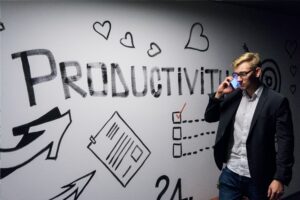 Man in front of white board that says productive, Platinum Resumes, Kansas City, MO