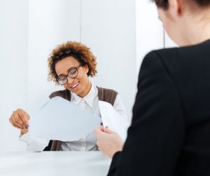 Woman interviewing looking at resume